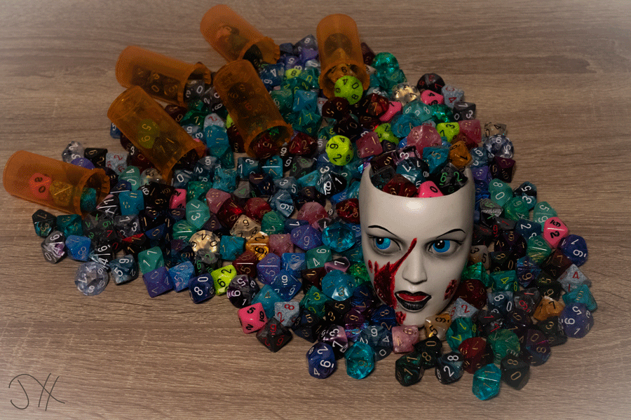 A photograph of a ceramic head with 10-sided dice of various colours spilling out of the top.